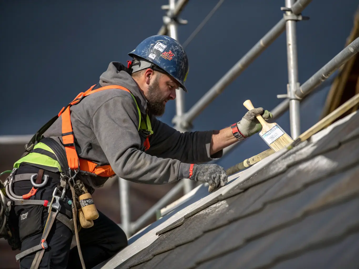 An eye-level shot of a commercial roofing repair in progress, with a TJB Construction worker carefully sealing a seam on a metal roof with specialized equipment. Safety gear is visible, emphasizing professionalism and safety.